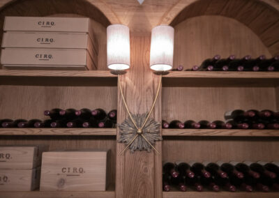 Sconces light up a wine cellar within a home