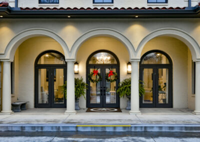 A grand entrance to a residence has views of their chandelier within