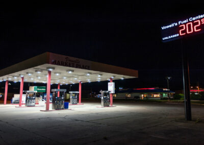 Vowells Service Station lit up at night with lighting by Robinson Electric