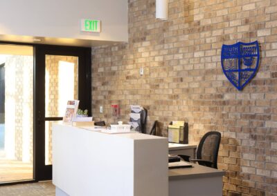 An interior image of a reception desk at Bayou Academy, with electrical work done by Robinson Electric.