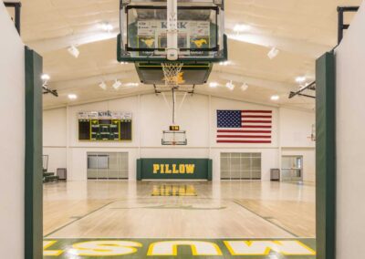 The Pillow Academy high school gymnasium is professionally lit and has an impressive scoreboard by Robinson Electric.