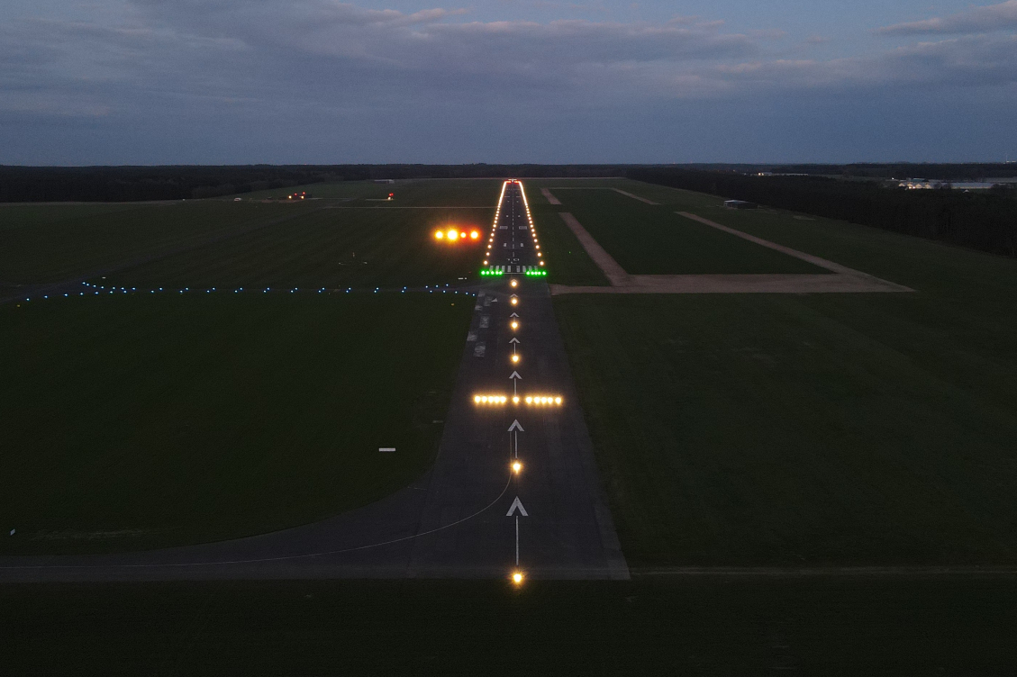 An airfield is illuminated on a dark night by lights installed by Robinson Electric.