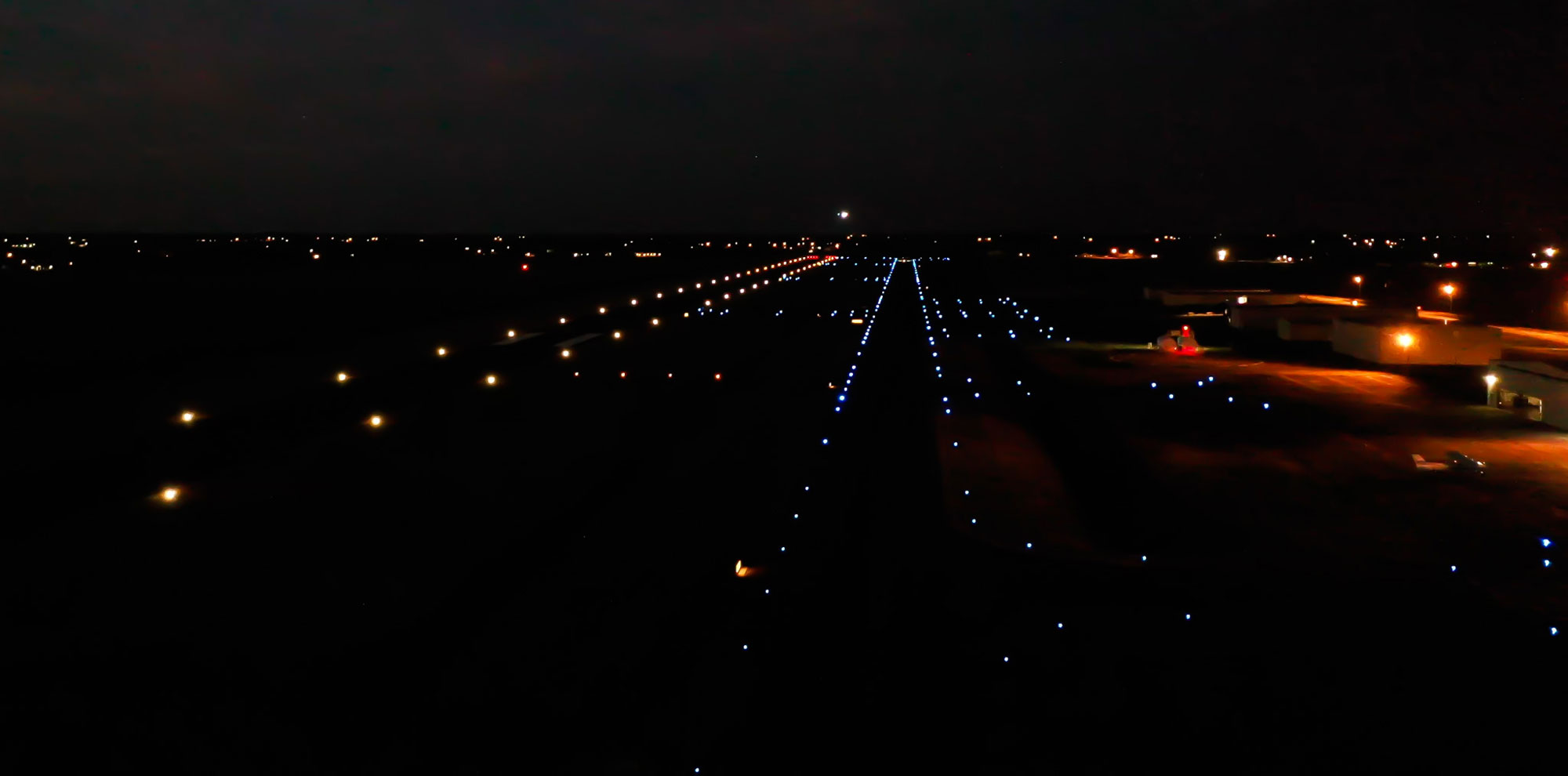 An airfield is illuminated on a dark night by lights installed by Robinson Electric.