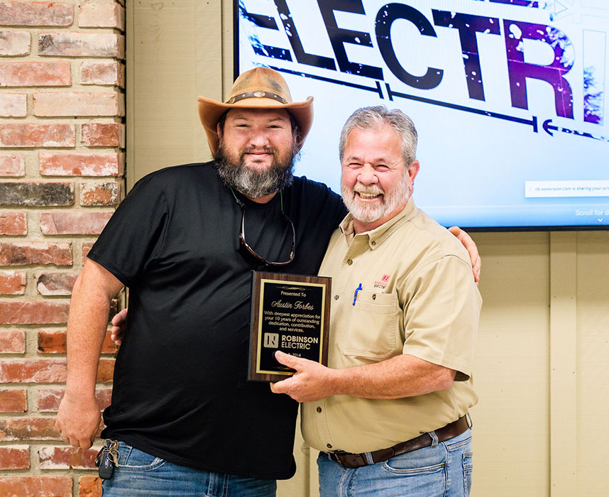 Kenneth Steadman stands with his plaque for Employee of the Year 2023.