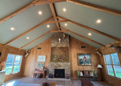 A modern yet rustic cabin has beautiful lighting by Robinson Electric. High ceilings have lights inlaid.