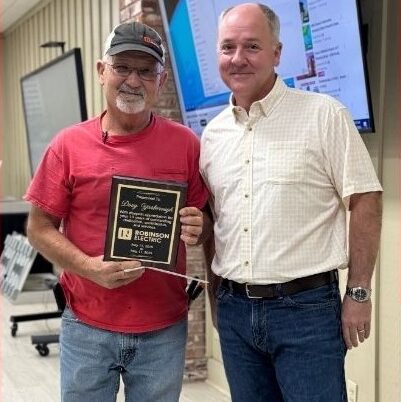 Doug, Employee of the Year, stands with Brian Robinson showing his plaque.