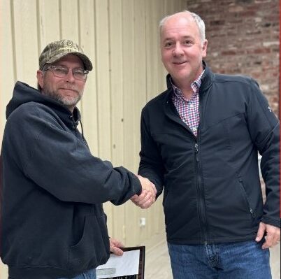 Kenneth Steadman stands with his plaque for Employee of the Year 2023.