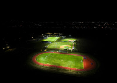 Sports fields at Bayou Academy shine in the night from a sky view